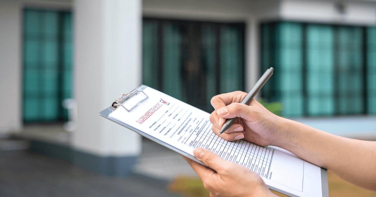 Person writing on clipboard the most common deficiencies in a senior living community.